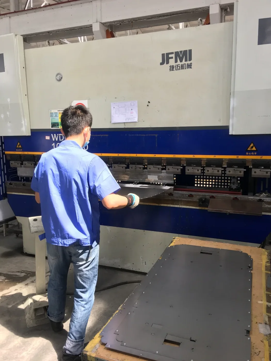 CNC press brake forming a large sheet-metal cladding panel
