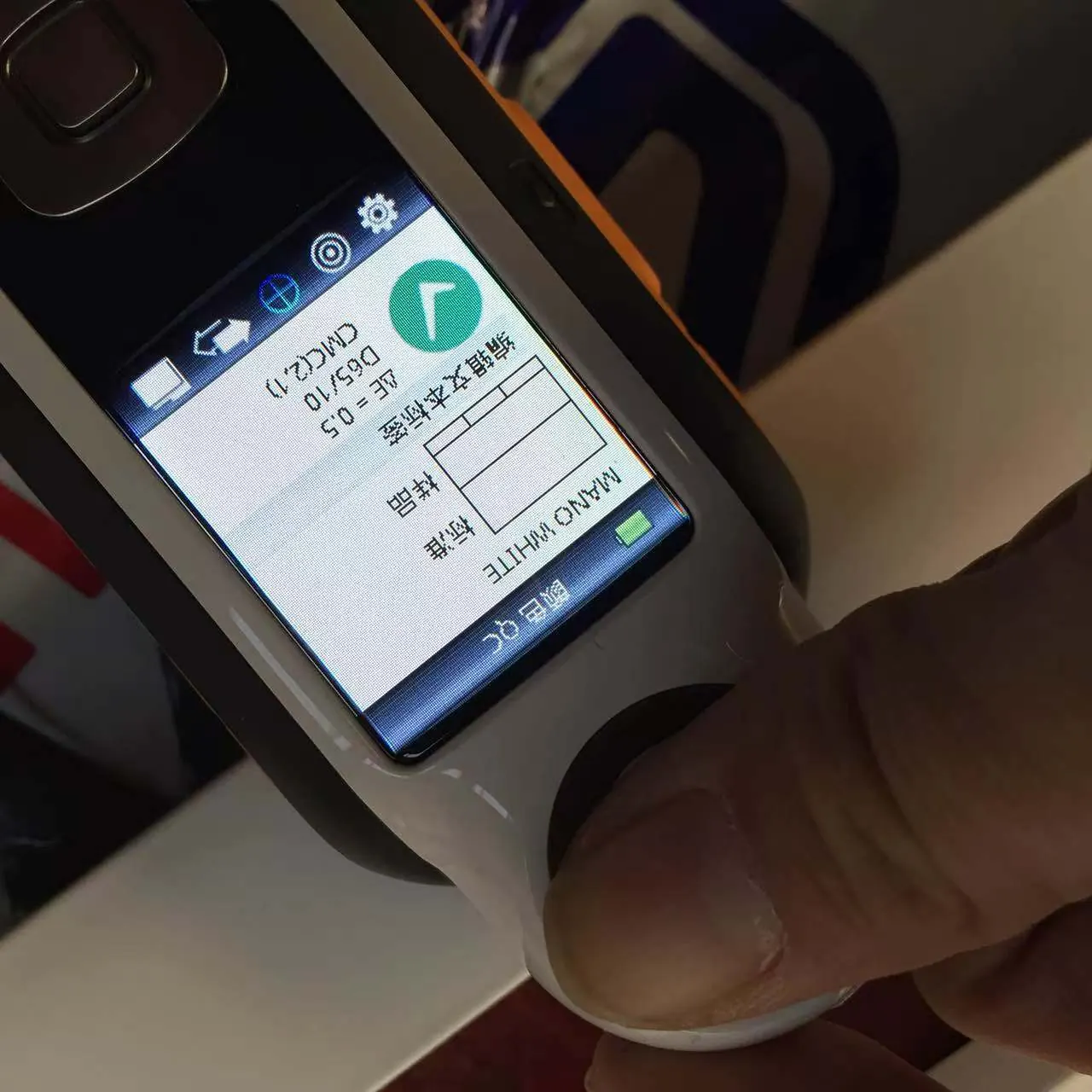 Portable color-difference meter checking a powder-coated aluminum part