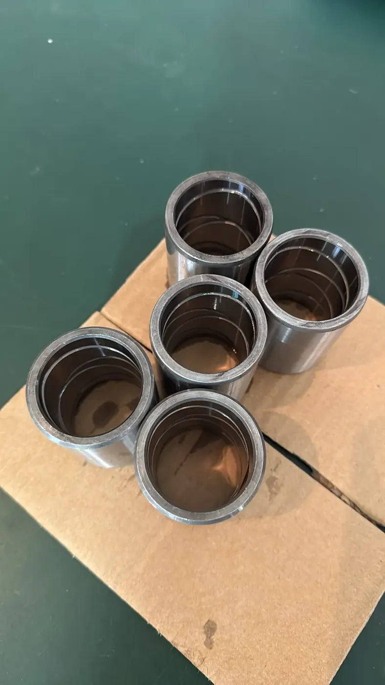 Machined inner wear bushings with lubrication grooves