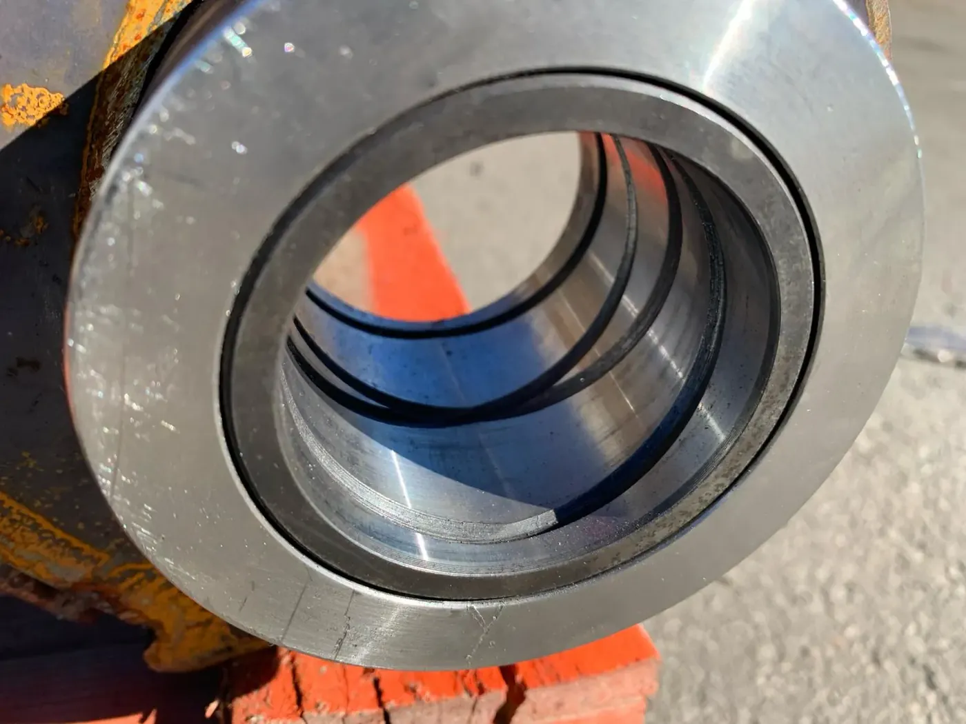 Close-up of a bushing assembly installed in a heavy-equipment linkage