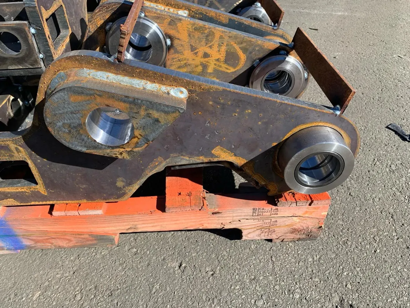 Heavy-equipment attachment with installed bushing assemblies