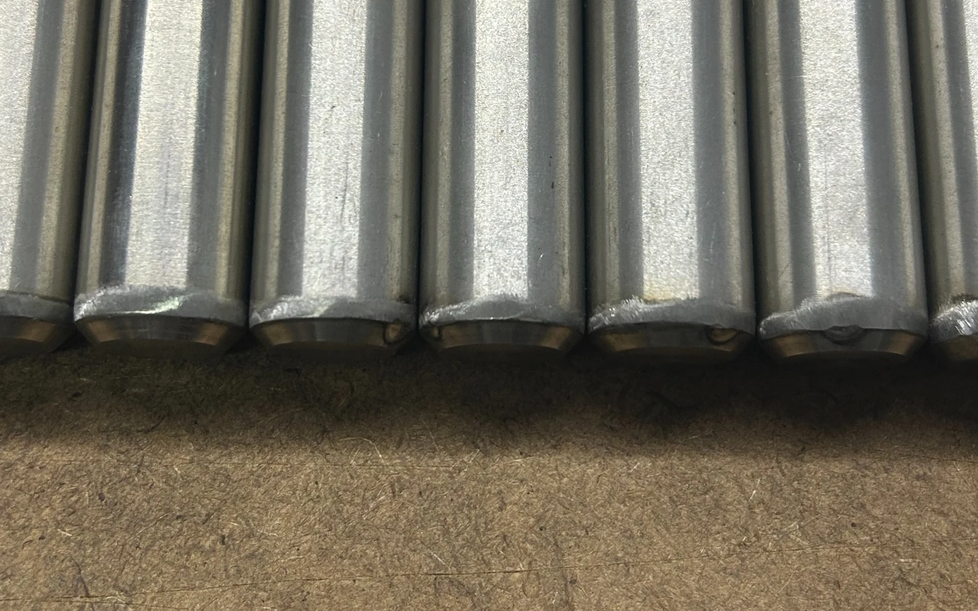 Close view of the welded and finished ends of stainless tubular components