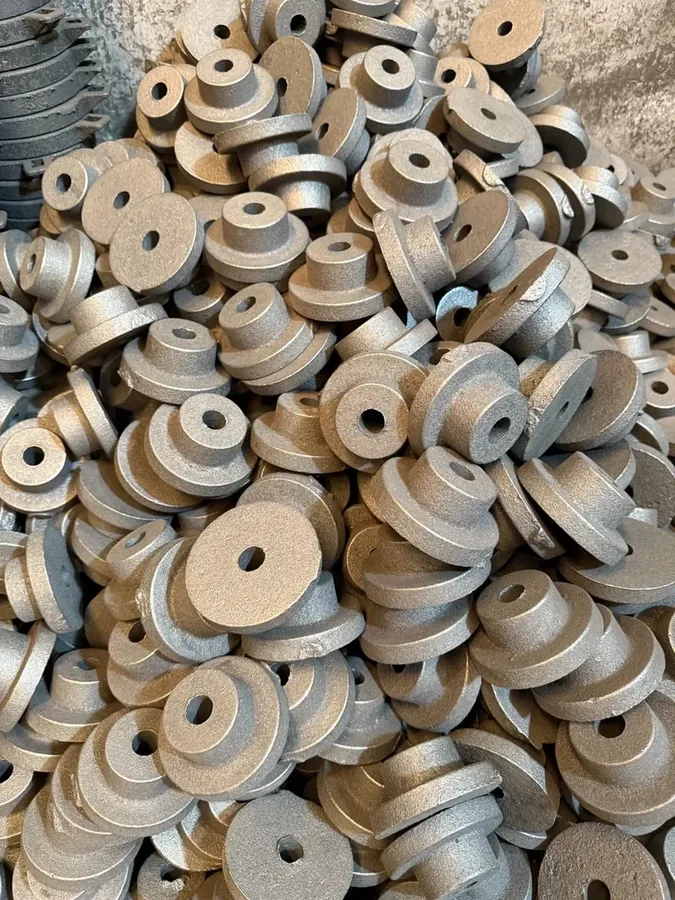 Small cast iron hub-style parts in raw foundry condition