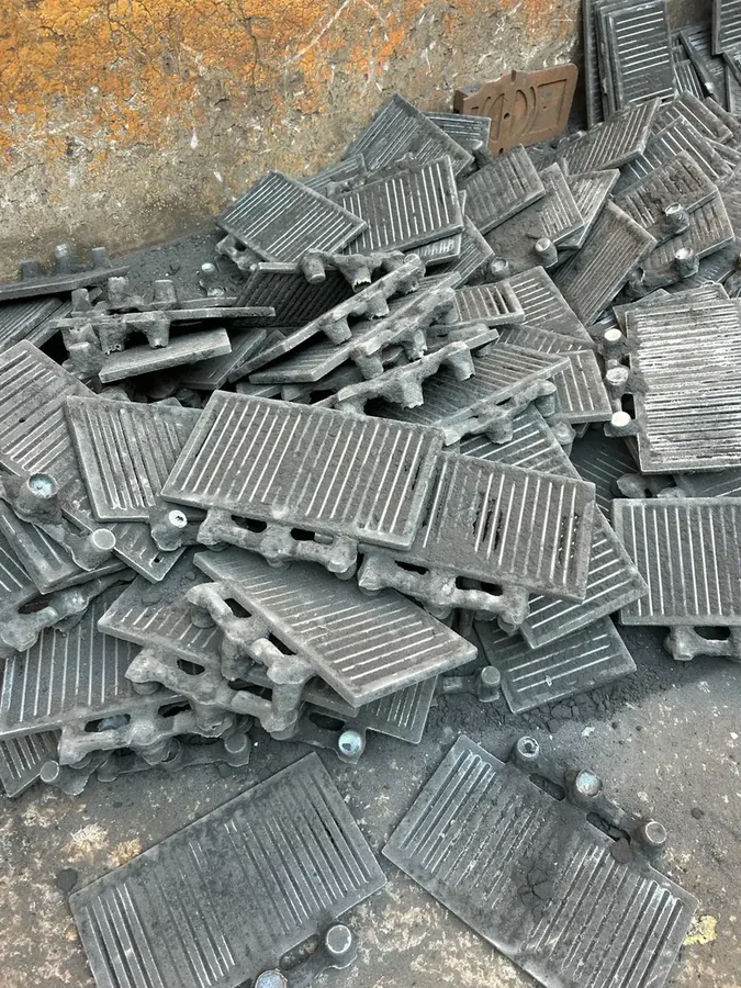 Cast iron grate plate components after shakeout