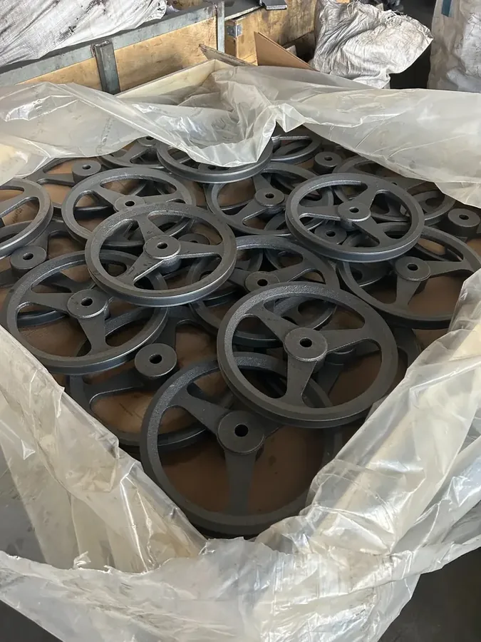 Cast iron pulleys packed inside a wooden crate