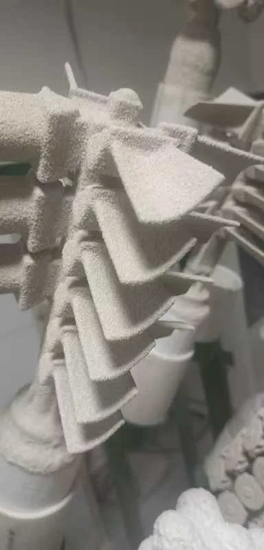 Ceramic shell built around turbocharger blade wax patterns